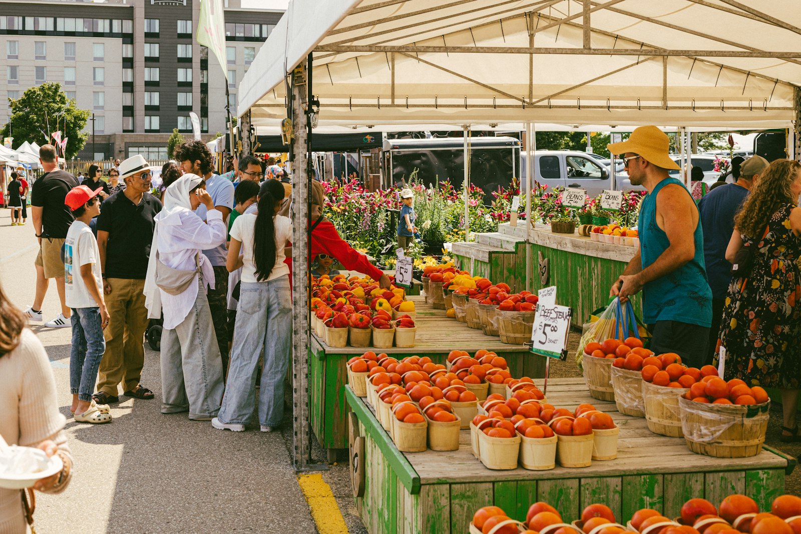 Busy farmers market with produce stalls
