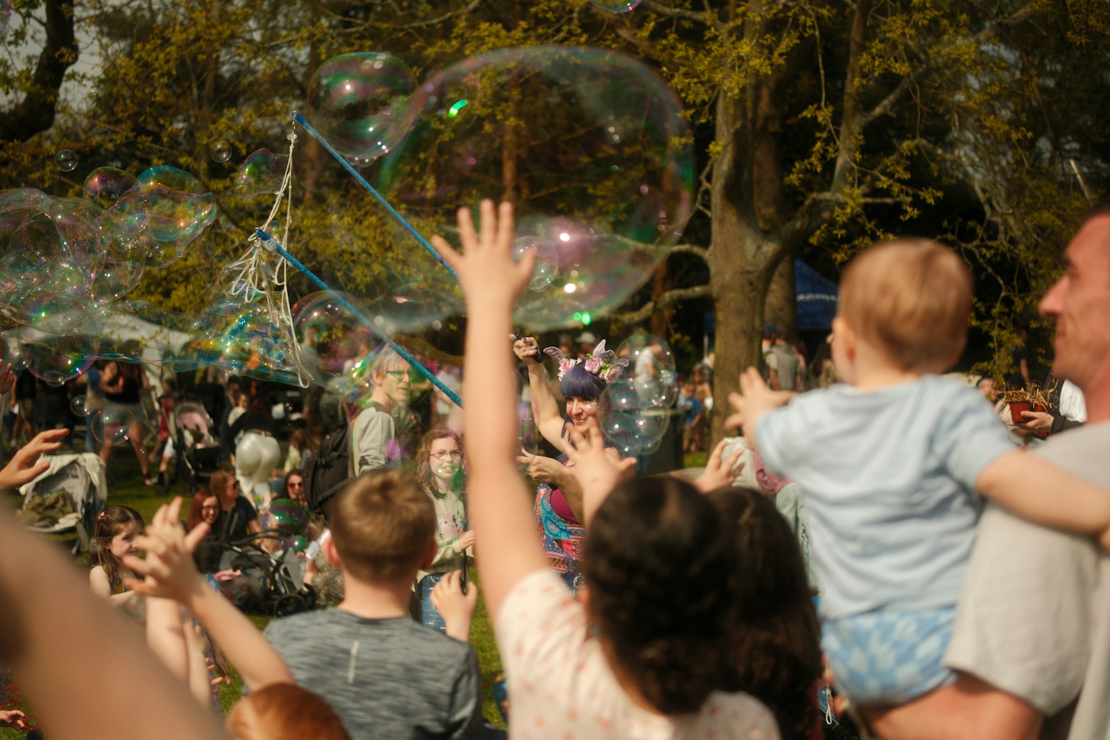 Kids chasing bubbles at a community event