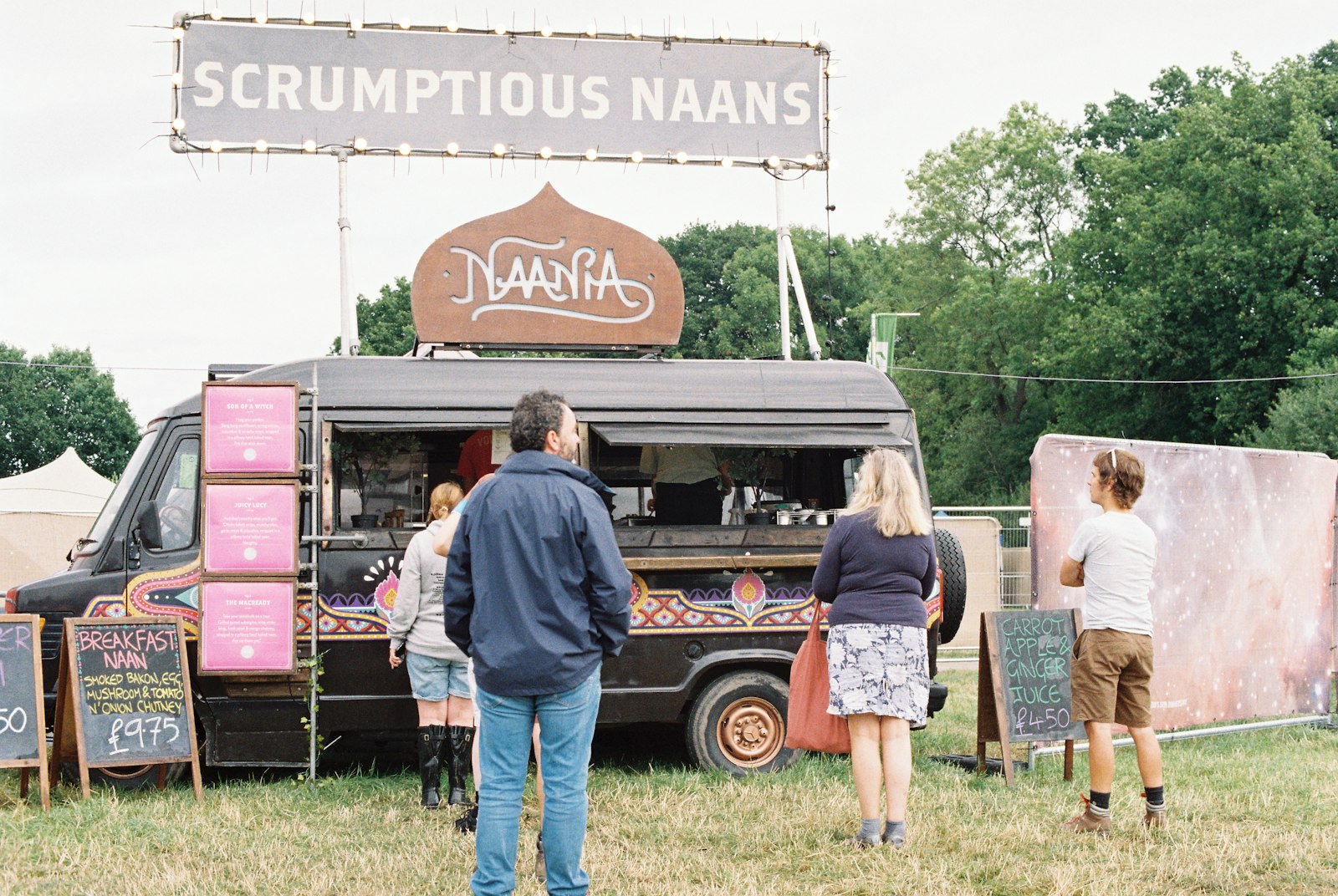Guests lining up at a food truck on the lawn
